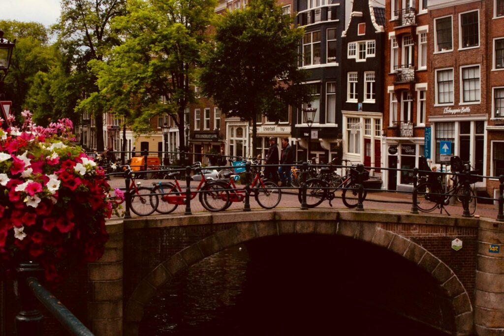 Amsterdam canal with flowers and  bicycles 