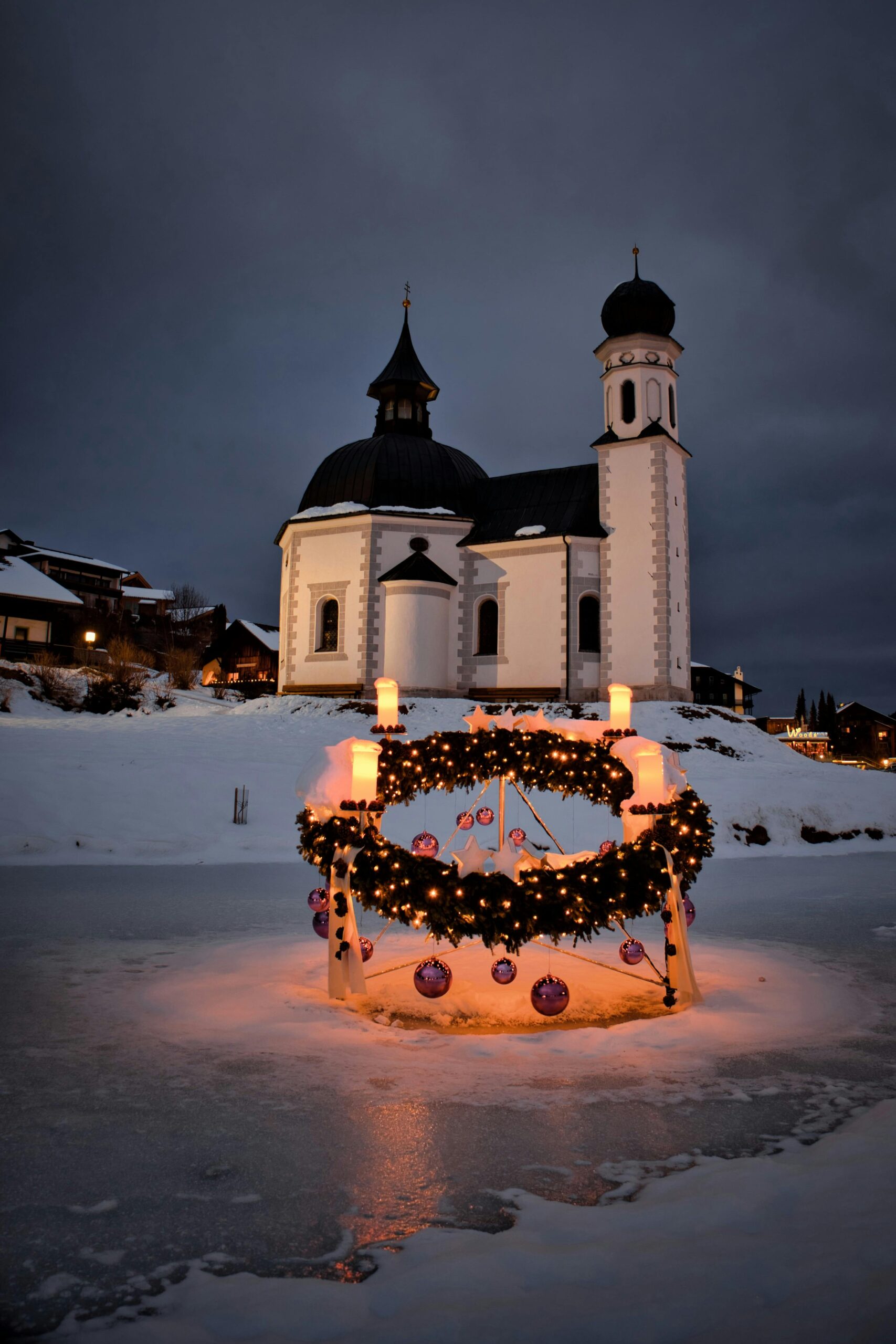 church with wreath in front of it. Symbolism tied to the pagan origins of Christmas.